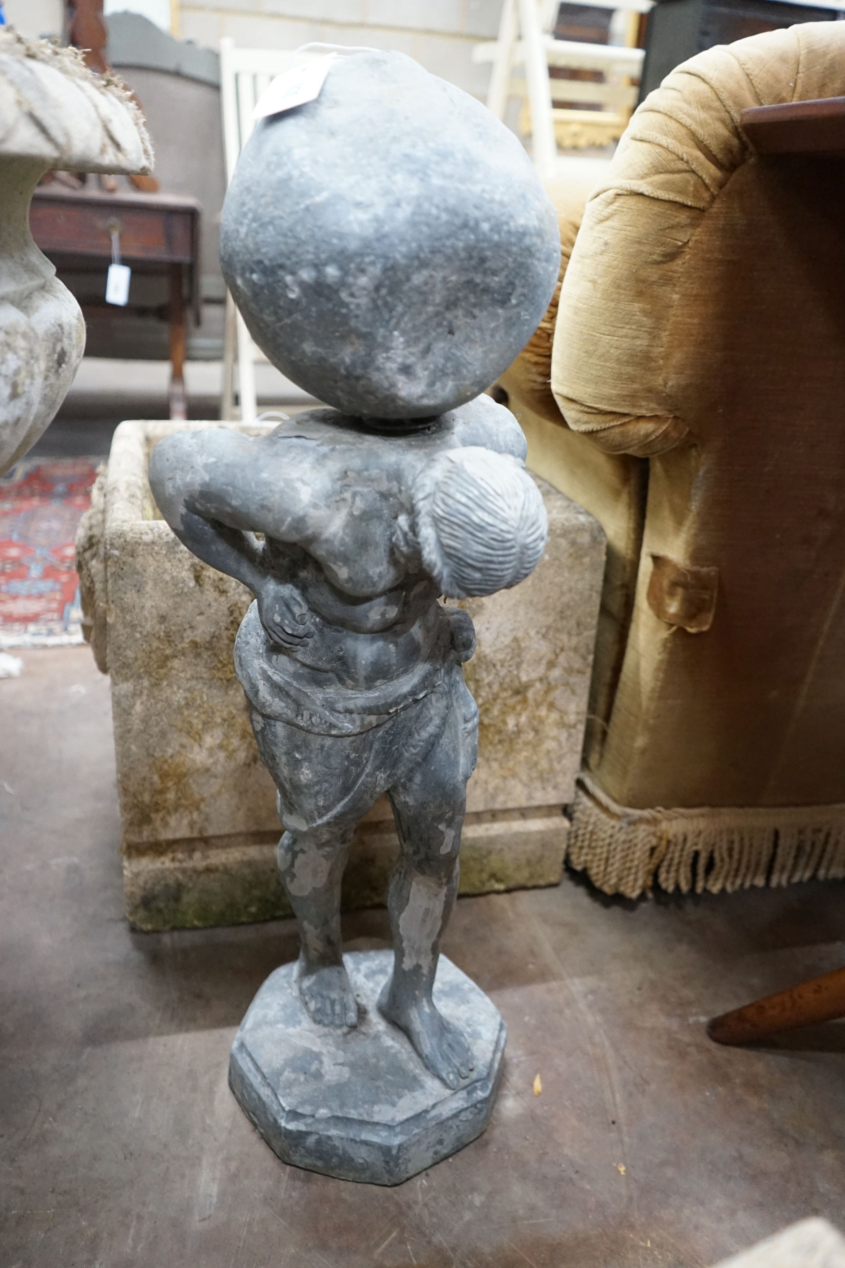 A small weathered lead garden ornament of Atlas, height 74cm